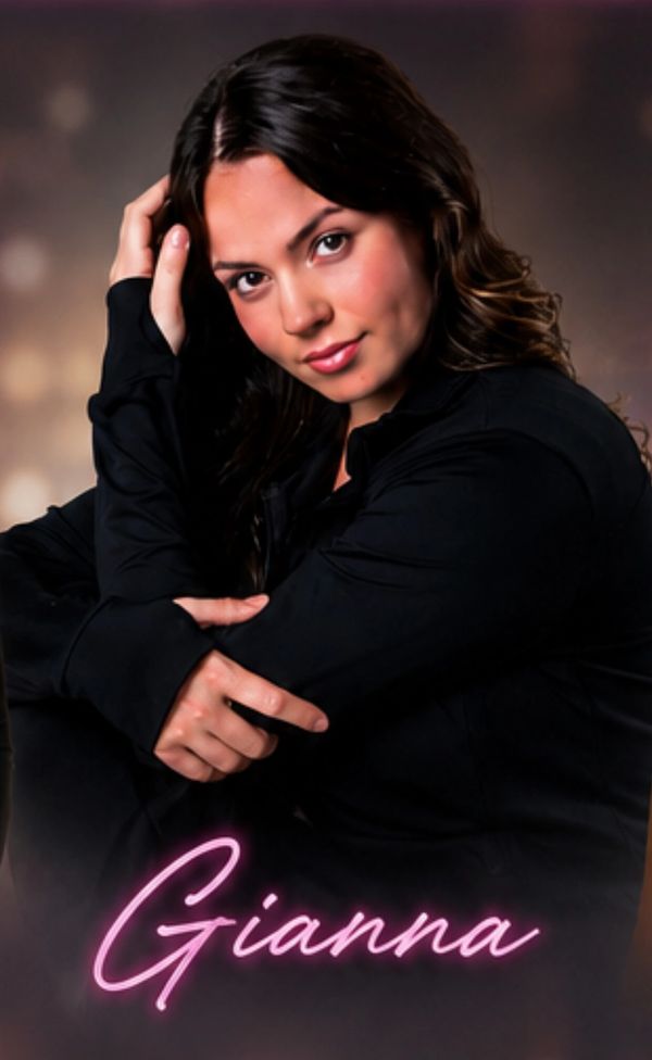 Portrait of a woman named Gianna in a black outfit.