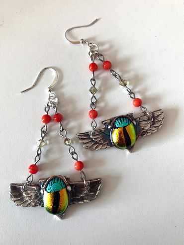 Colorful scarab beetle earrings with wings and bead chains.
