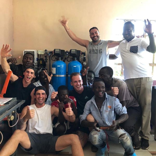 Hombres delante de una máquina potabilizadora.