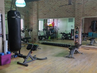 Fitness room with many things to choose from such as a punching bag, foam rollers, and dumbbells.
