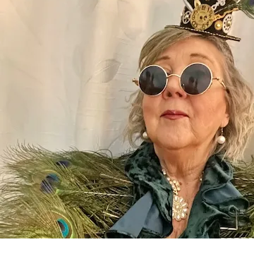jane elzey dresses as mrs peacock with steam punk hat and glasses