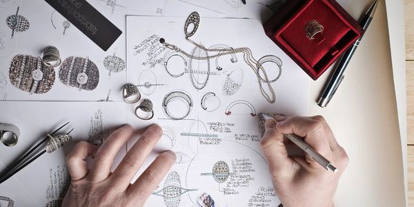 A designer at work using drawing paper and sketching ideas.