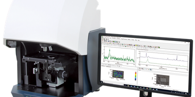 Scientific instrument with computer monitor displaying data and graphs.
