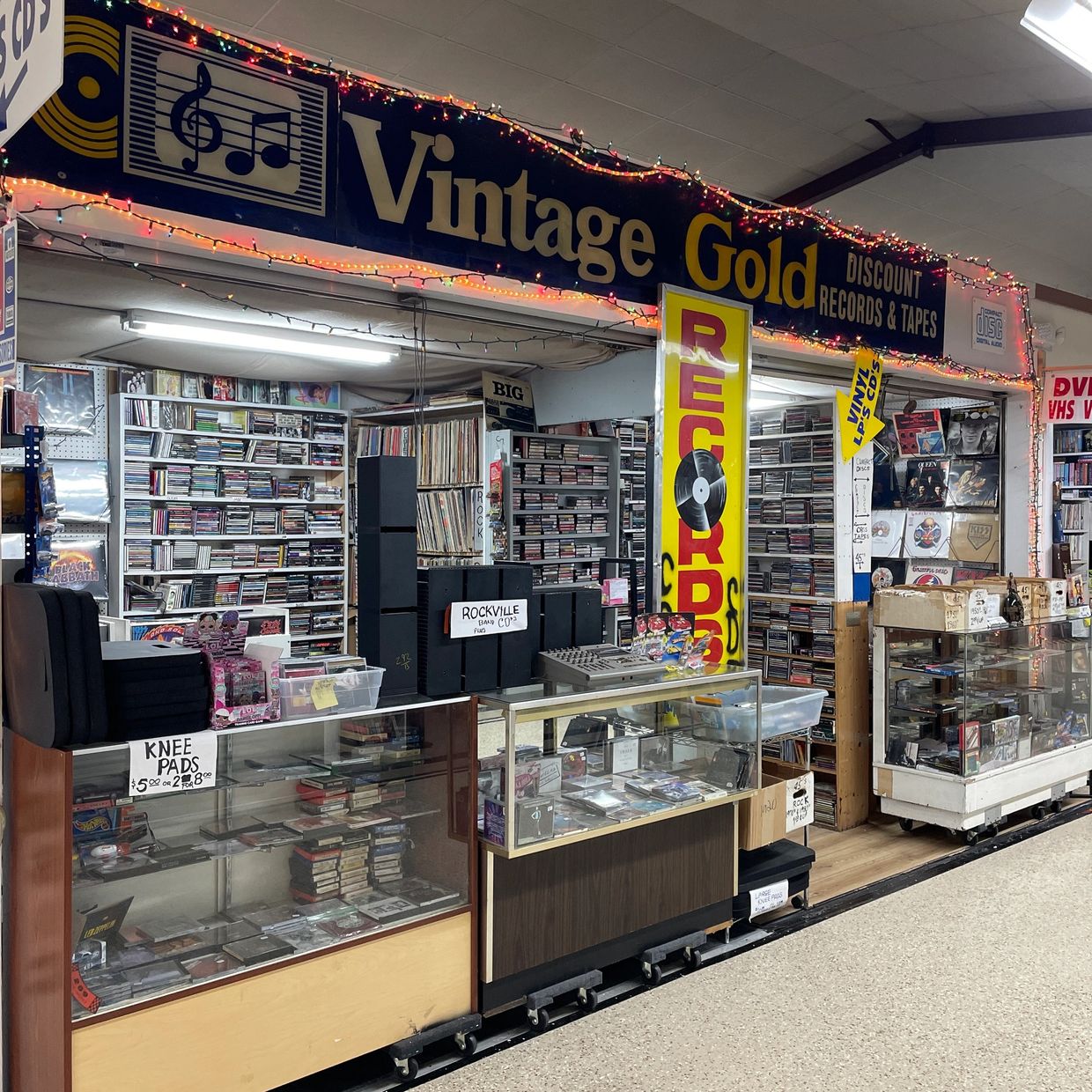 Wall of vintage Mustang signs and memorabilia in music-themed booth.