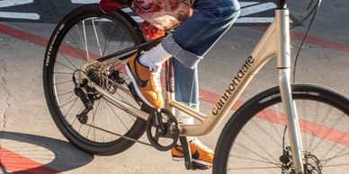 Person riding a Cannondale bike with orange shoes.