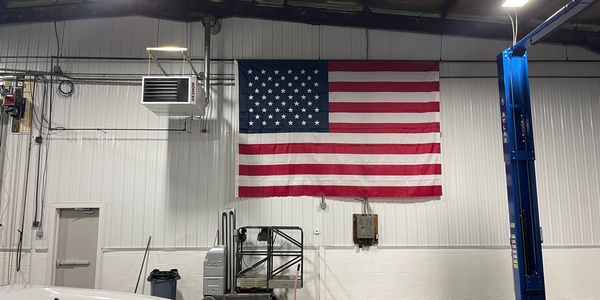 American Flag being flown inside Impact Truck Service garage