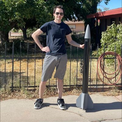 Founder and CEO Ryan Shelton next to the level one high power rocket Stratus-V3.