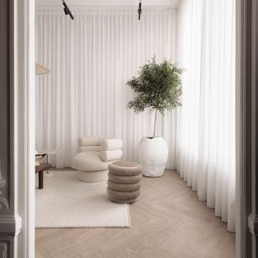 Minimalistische kamer met neutrale kleuren en moderne meubels.