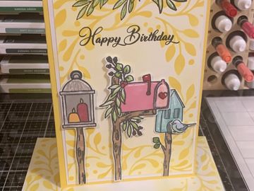 Handmade birthday card featuring illustrated mailboxes and a bird.