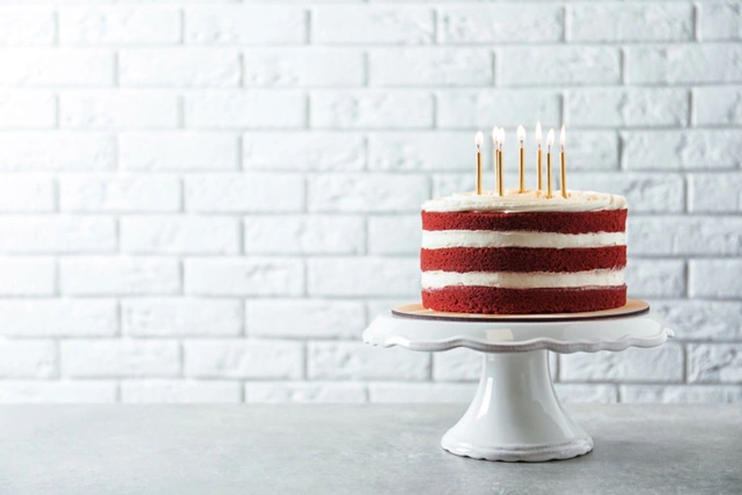 cake with candles on a cake stand 