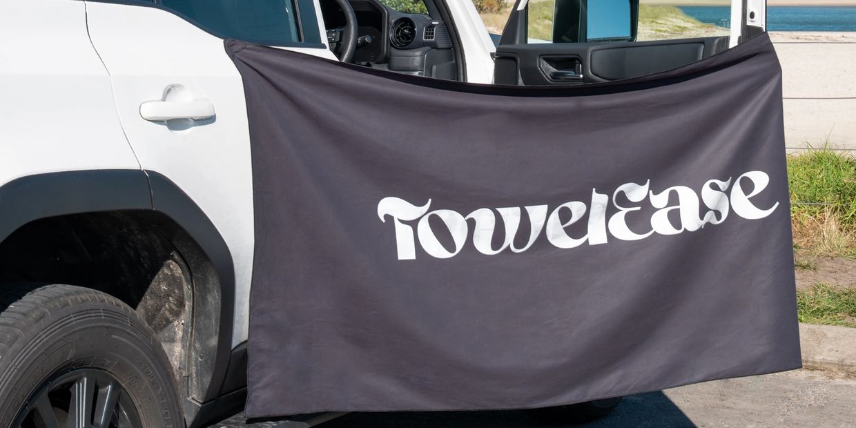 Black magnetic beach towel on car door