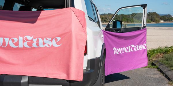 Purple and Pink towels attached to the car with magnets