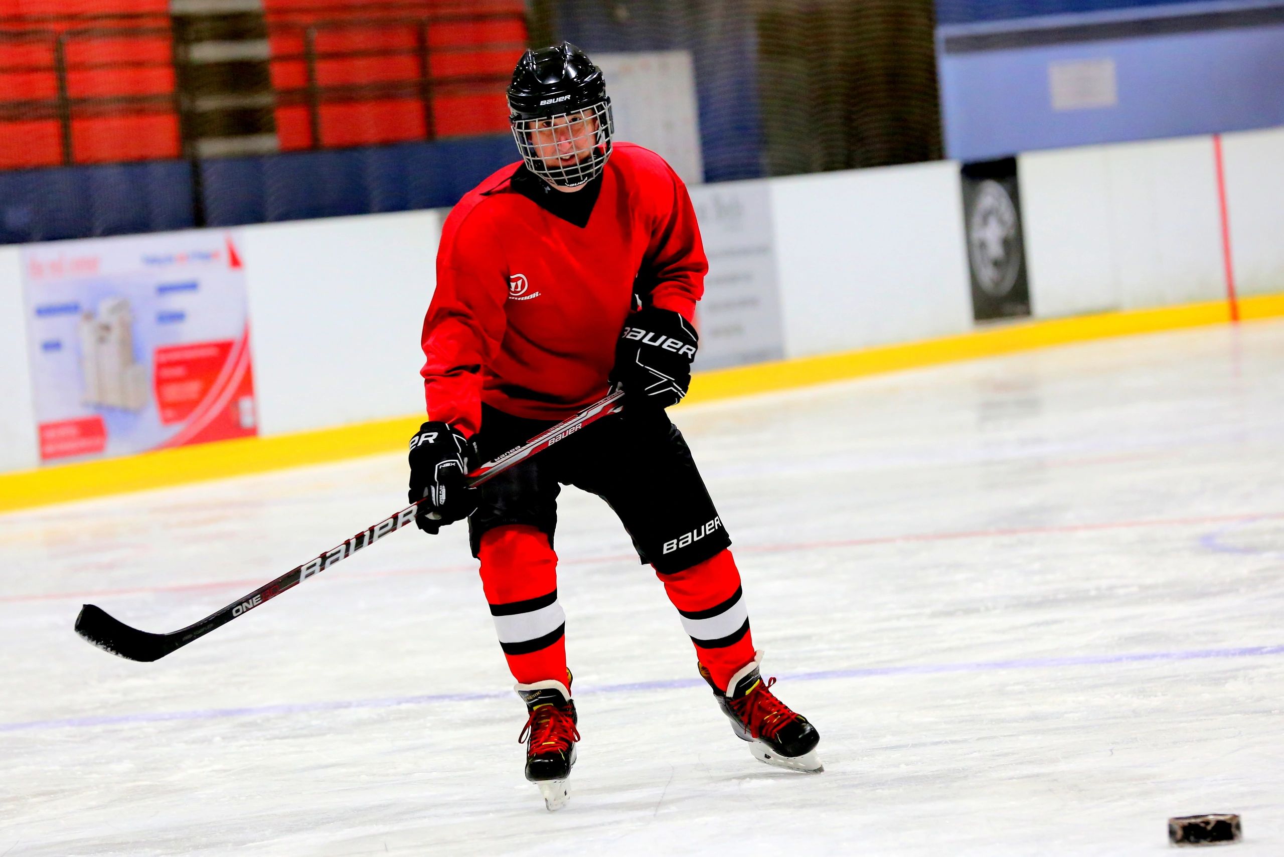 Hockey player chasing down a blind puck