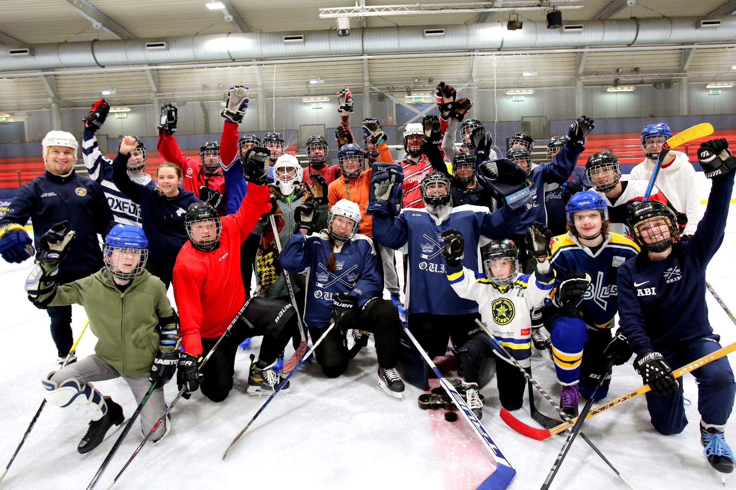 Photo of visually impaired ice hockey players and supporters on the ice after a Try Blind Hockey ses