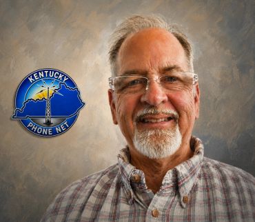 Portrait of a smiling man with Kentucky Phone Net logo.