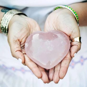 A man holding a heart shape ice in his hand