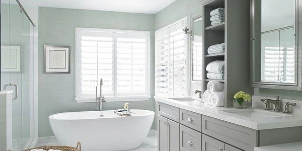 Freestanding tub with double sink vanity and glass shower enclosure