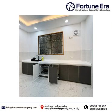 Modern kitchen with sleek cabinetry and a marble floor.