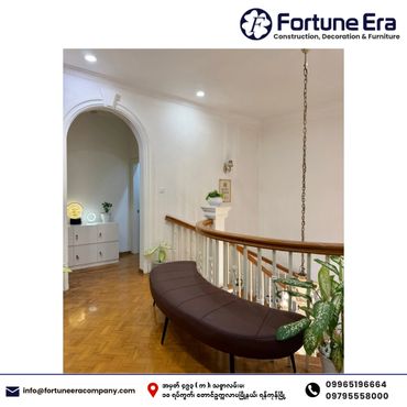 Elegant indoor seating with curved bench and wooden railing in a well-lit hallway.