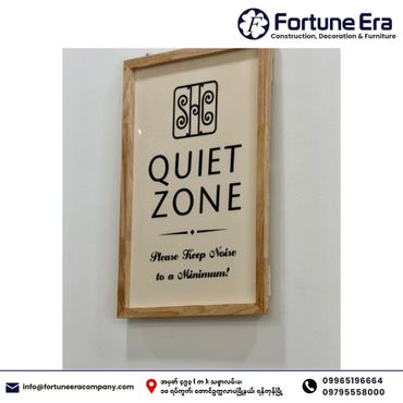 Framed sign indicating a quiet zone with a polite noise reminder.