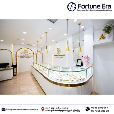 Elegant jewelry store interior with glass displays and gold accents.