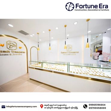 Bright, modern jewelry store interior with sleek glass displays and gold accents.