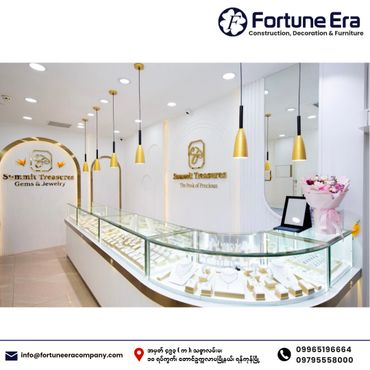 Modern jewelry store interior with glass display cases and elegant lighting.