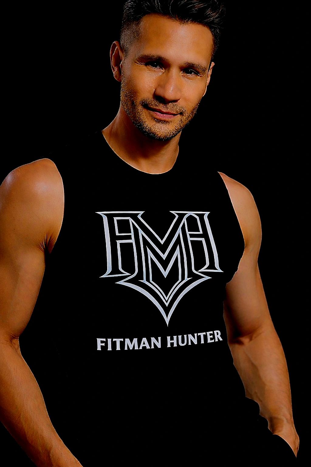 Fit man wearing a black sleeveless shirt with 'Fitman Hunter' logo.