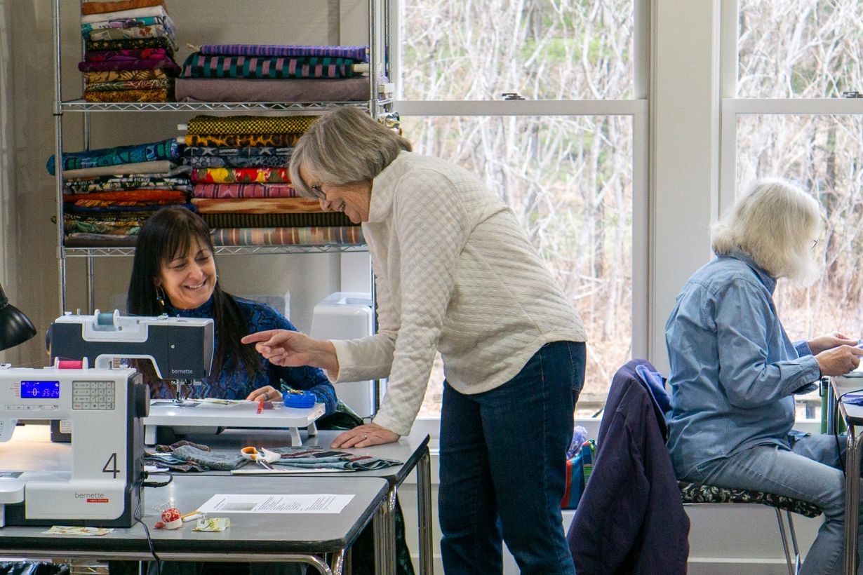 Teaching artist and students making together in the fiber studio.