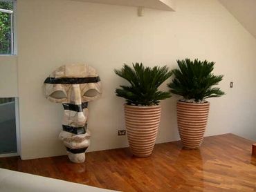 Marble Sculpture and Italian Terracotta Pots used internally with lush indoor tropical plants. 