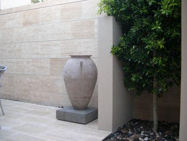 Modern Italian Amphora as central feature on small courtyard