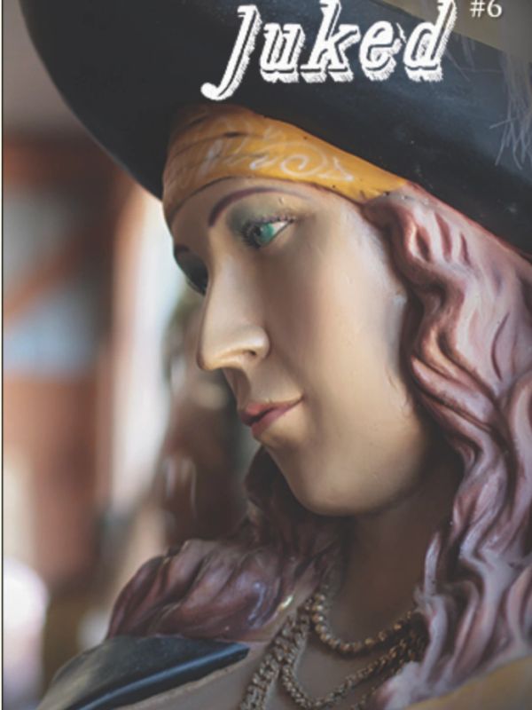 Close-up of a pirate statue with a yellow bandana.