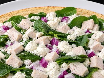 Spinach and ricotta wrap with chicken and onions.
