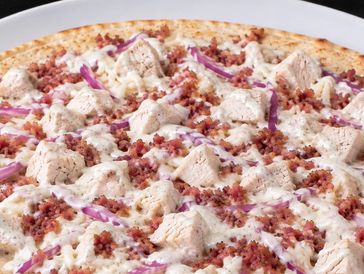 Chicken bacon ranch pizza with red onions.