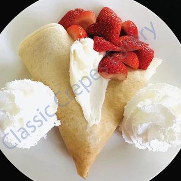 Crepe with strawberries and whipped cream.