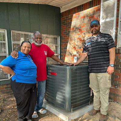 Family and service provider smiling infront of an AC unit.