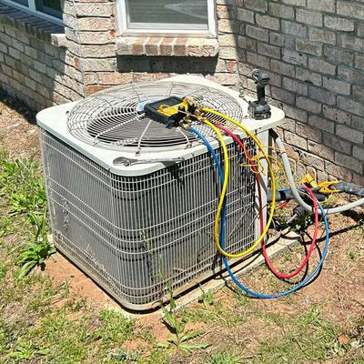 Home AC unit with gauges hooked up to it assessing a problem 