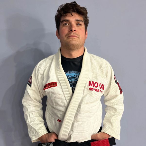 Man in a martial arts gi with a black belt.