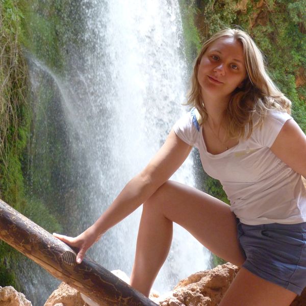 Self posing next to waterfall 