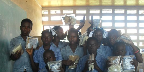 Packets of food being distributed to orphanage schools in the Artibonite Valley in Haiti.