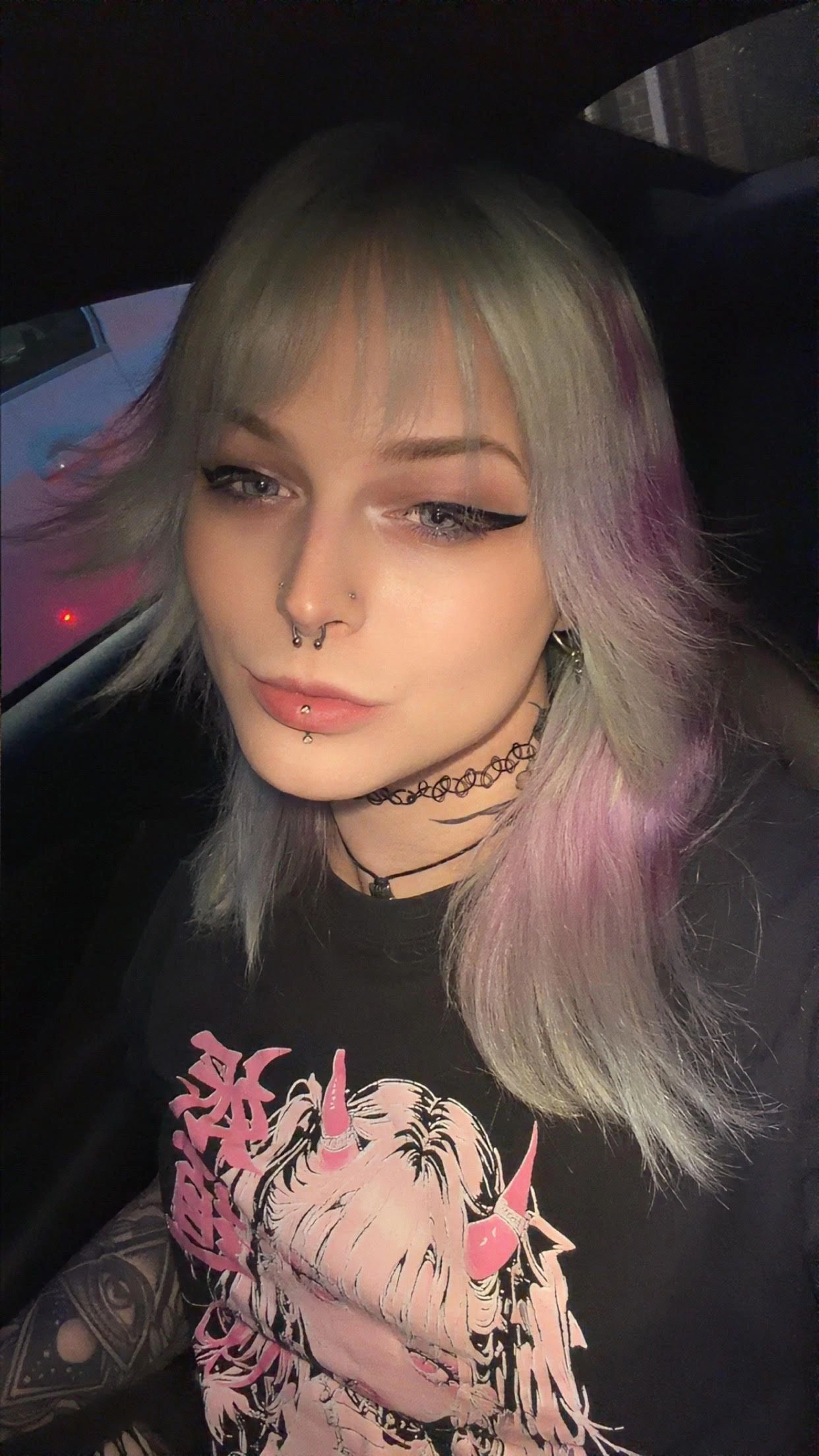 Person with piercings in a car.