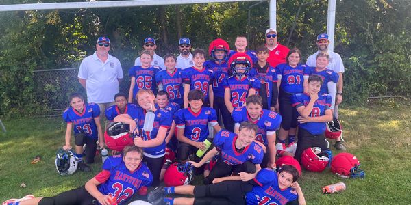 The Hartford Mini-Canes 5th & 6th grade team photo on the field in their blue jerseys.