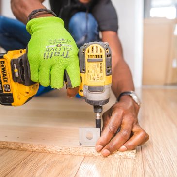 person using a drill on wooden board
