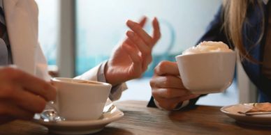 Two people having a calm conversation over coffee in a relaxed setting