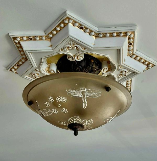 Ornate ceiling light fixture with dragonfly and floral designs.