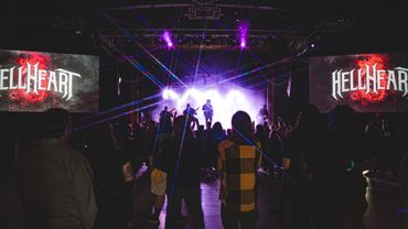 Live concert with Hellheart performing on stage, colorful lights, and an engaged crowd.