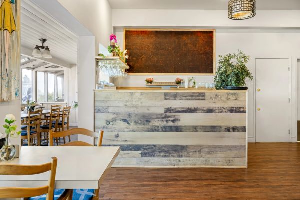Cozy restaurant interior with wooden furniture and a service counter.