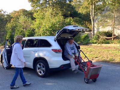 Kathy laughing at (or with?) Tom as he tries to maneuver to 220 lb. tamper.  
