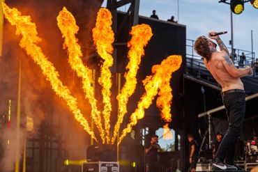 Concert performer with pyrotechnics in the background.