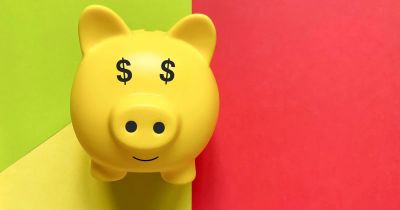 Yellow piggy bank with dollar signs for eyes.